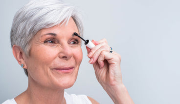 An older women with thinning brows applying NULASTIN BROW serum.