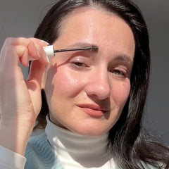 UGC creator applying Nulastin Brow serum