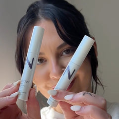 Influencer holding Nulastin lash and brow and smiling after seeing fuller looking lashes and brows