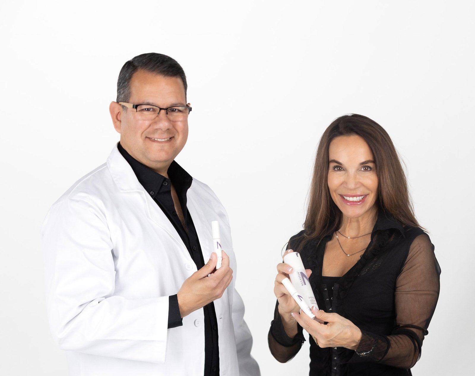 Chief Science officer and Founder holding Nulastin serums and smiling