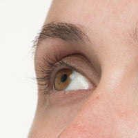 A woman's eye at week 6 on her Nulastin lash and brow renewal journey