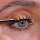 Fast paced video of women applying eyelash serum and close ups of the applicator