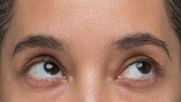 Close-up of a person's eyebrows and upper eyelids showing visibly fuller, denser brow hairs