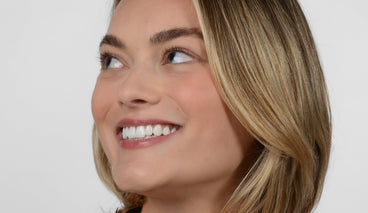 Young, blonde haired woman with long lashes wearing no mascara.