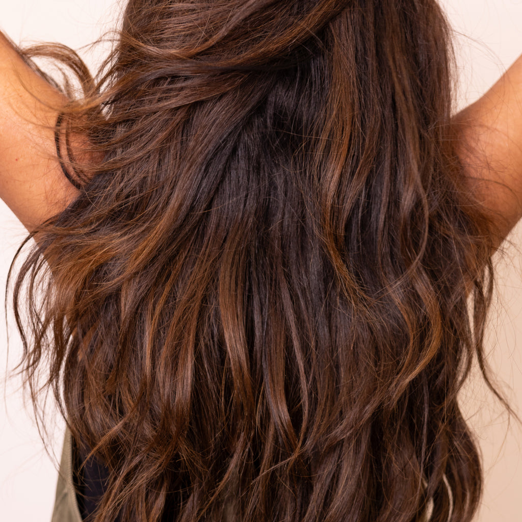 Brunette with full, silky hair powered by Nulastin Repair & Smooth Conditioner  