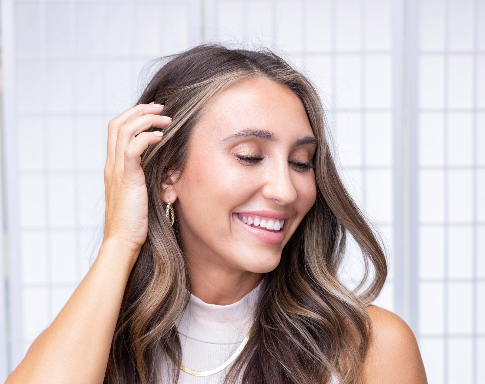 Young woman touching her hair and smiling