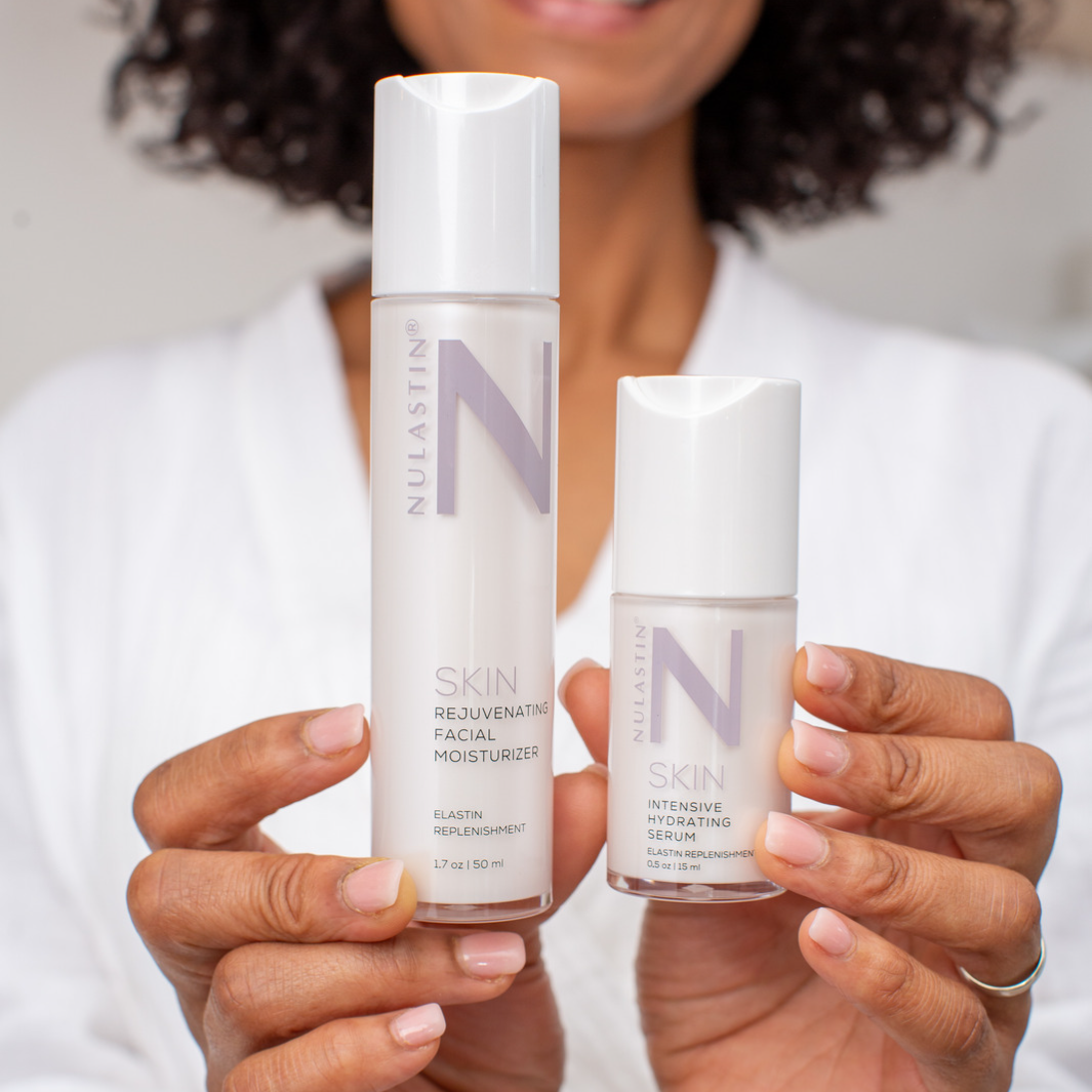 Woman holding two bottles in NULASTIN 2-step skincare routine