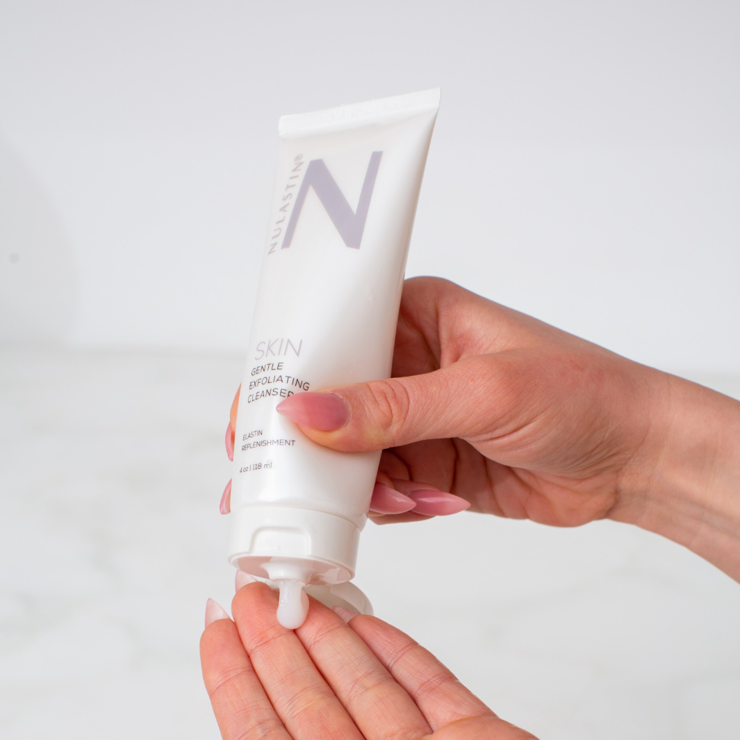 Hands applying NULASTIN skin cleanser to hands in front of white background