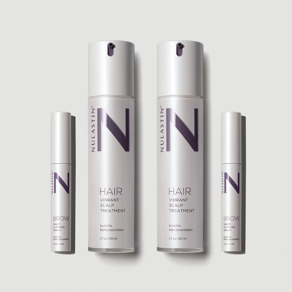 Four white bottles of NULASTIN hair and brow serums against white background