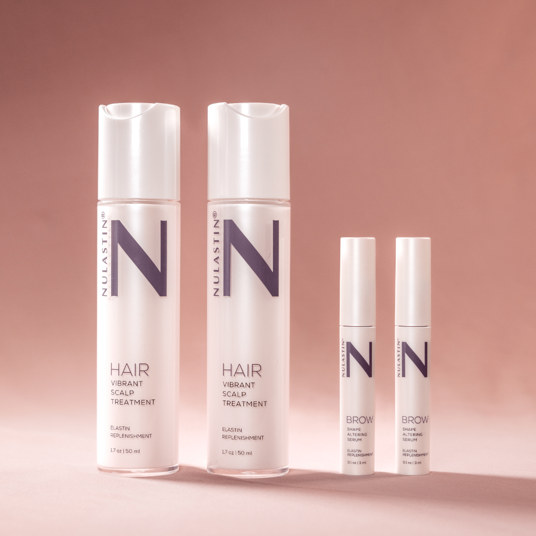 NULASTIN hair and brow product bottles against light pink background 