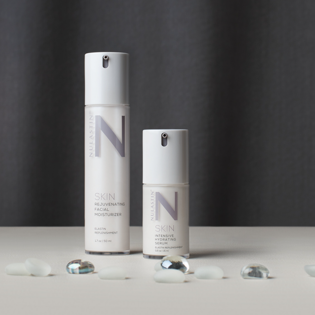 NULASTIN 2-step skincare moisturizers on white surface with glass rocks in foreground against grey background 