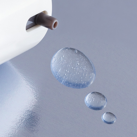 Drops of Nulastin Hair Product on shiny surface