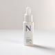 White Skin Serum Bottle Casting Shadow on white surface