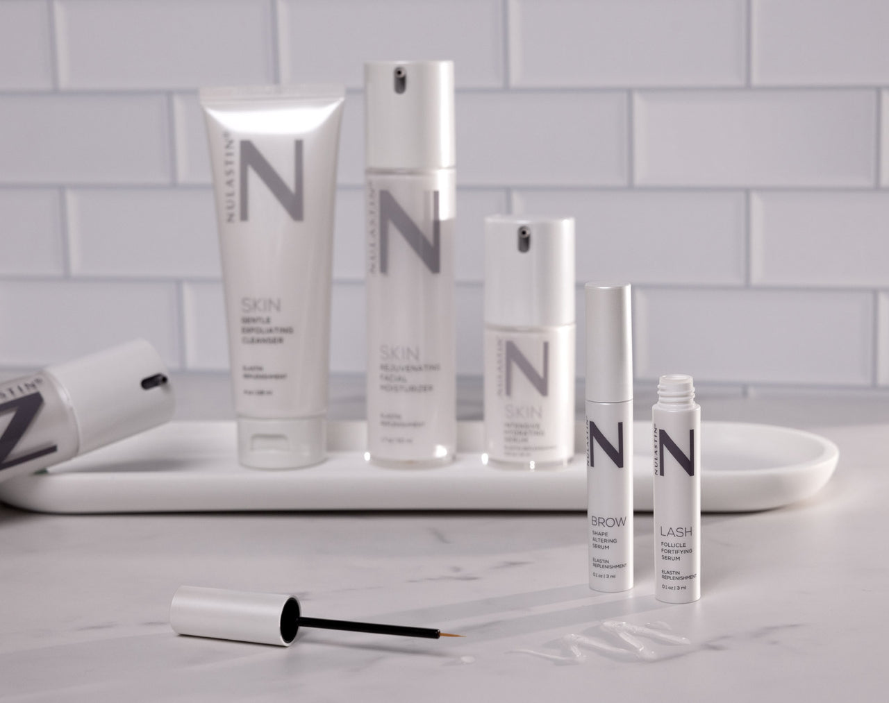 Nulastin subscription order including lash and brow serums and the radiant skincare systems