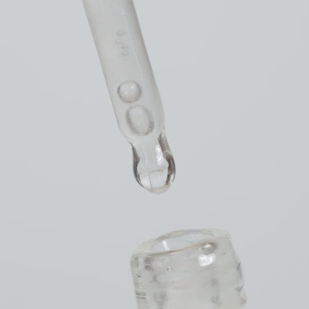 Video of clear serum applicator in bottle against white background